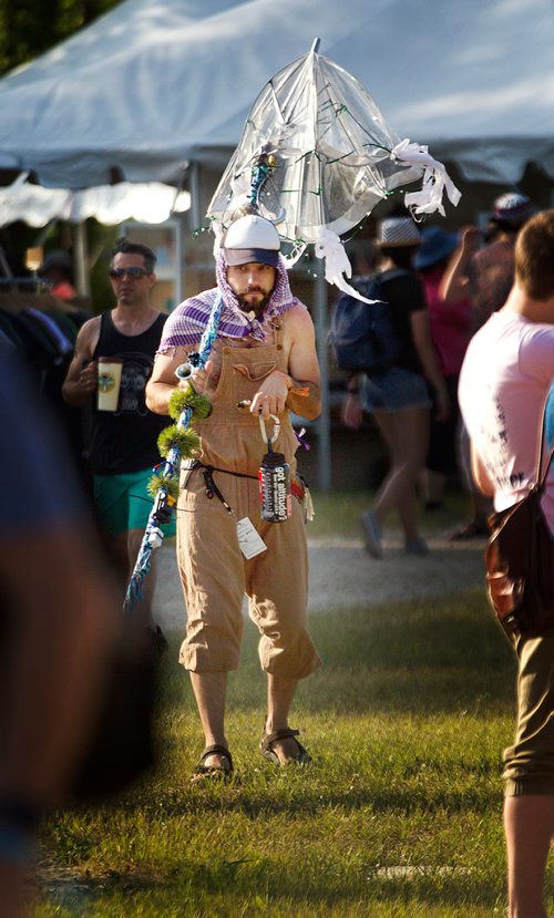 PHIL HOSSACK / WINNIPEG FREE PRESS - Folk Festival- Like a pilgrim arriving at mecca Marc Bosc arrives at the festival site Thursday with his tarp site marker so his friends can find the location of his tarp opening night at the Folk Festival. - July 11, 2019.