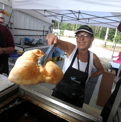PHIL HOSSACK / WINNIPEG FREE PRESS - Whales Tales Sharon Doornsbosch shows  Whale's Tail hot outta the fryer at the Folk Festival Thursday. - July 11, 2019.