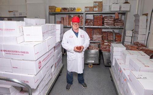 SASHA SEFTER / WINNIPEG FREE PRESS
Owner of Winnipeg Old Country Sausage Ken Werner holds some of the companies popular Pepperettes in the packaging room at their facility in Dufferin.
190712 - Friday, July 12, 2019.
