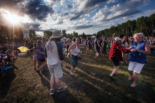 PHIL HOSSACK / WINNIPEG FREE PRESS - Folk Festival -  Festival goers dance the evening away as the sun sets at the Winnipeg Folk Festival site Friday. - July 12, 2019.