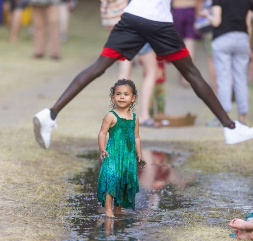 SASHA SEFTER / WINNIPEG FREE PRESS
While some might not want to get their feet wet, Milaya Rhodes (2) cools off by splashing in a puddle during the 46th annual Winnipeg Folk Fest held in Birds Hill Park.
190713 - Saturday, July 13, 2019.