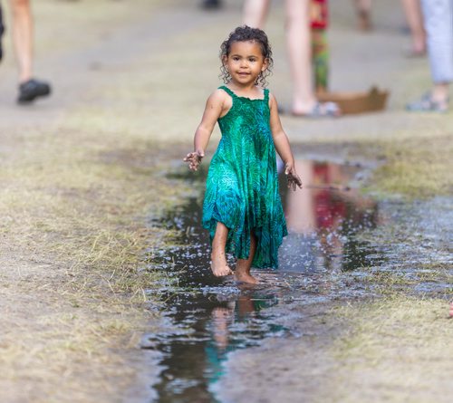 SASHA SEFTER / WINNIPEG FREE PRESS
Milaya Rhodes (2) cools off by splashing in a puddle during the 46th annual Winnipeg Folk Fest held in Birds Hill Park.
190713 - Saturday, July 13, 2019.