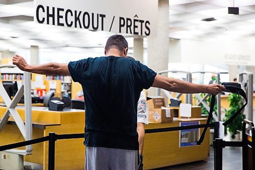 MIKAELA MACKENZIE / WINNIPEG FREE PRESS
Library patron Blaine Albany goes through the security screening at the Millennium Library in Winnipeg on Monday, July 22, 2019. For Tessa Vanderhart story.
Winnipeg Free Press 2019.