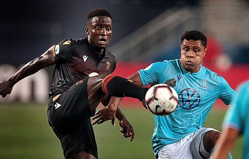 PHIL HOSSACK / WINNIPEG FREE PRESS - Valour FC #27 Raphael Ohin kicks the ball ahead of Pacific FC #14 Terran Campbell at IG Field Wednesday evening. See Story. July 31, 2019