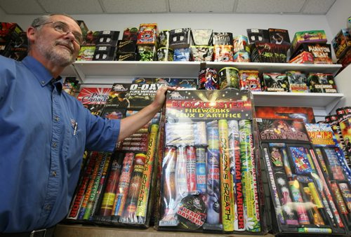 Brandon Sun Bob Freeman shows the shelves of fireworks as the Hi-Way Esso gears up for Canada Day, Monday afternoon. FOR COLLEEN STORY (Colin Corneau/Brandon Sun)