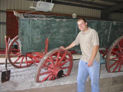 Elliot Sims stands beside a vintage grain wagon stuck in mud, as they often were, at a new exhibit he spearheaded at the Manitoba Agricultural Musuem¤near Austin. Bill Redekop photo Winnipeg Free Press