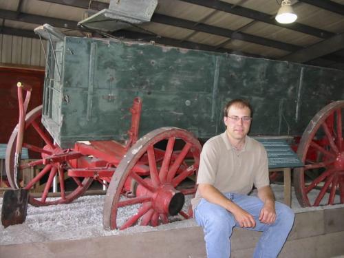 Elliot Sims stands beside a vintage grain wagon stuck in mud, as they often were, at a new exhibit he spearheaded at the Manitoba Agricultural Musuem¤near Austin. Bill Redekop photo Winnipeg Free Press