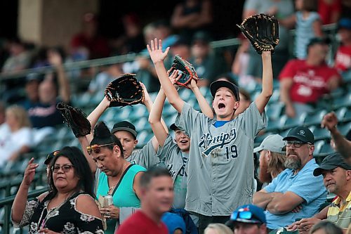 PHIL HOSSACK / WINNIPEG FREE PRESS - Boys of summer baseball fans gesture trying to get the attention of promotions staff firing free t-shirts into the crowd Friday evening at Shaw Park.  - August 16, 2019.