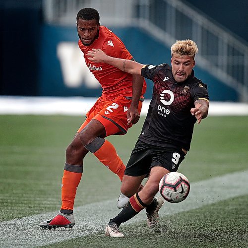 PHIL HOSSACK / WINNIPEG FREE PRESS - Forge #2 Grant Jonathan loses the ball to ValourFC #9 Michael Petrasso at Investors Group Field Saturday evening. See story. - June 12, 2019