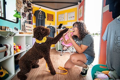 Mike Sudoma / Winnipeg Free Press
Up Dog Boutique owner Leslie Watson high fives her trusty side kick Murtagh inside their mobile store Saturday afternoon
August 17, 2019
