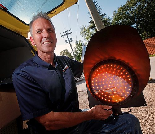 PHIL HOSSACK / WINNIPEG FREE PRESS - Electrical Contractor Chuck Lewis poses with a light similar to what he's going to install and maintain for FIVE years gratis for the city at reduced speed school zones.  See story - September 4, 2019.