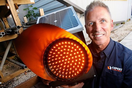 PHIL HOSSACK / WINNIPEG FREE PRESS - Electrical Contractor Chuck Lewis poses with a light similar to what he's going to install and maintain for FIVE years gratis for the city at reduced speed school zones.  See story - September 4, 2019.