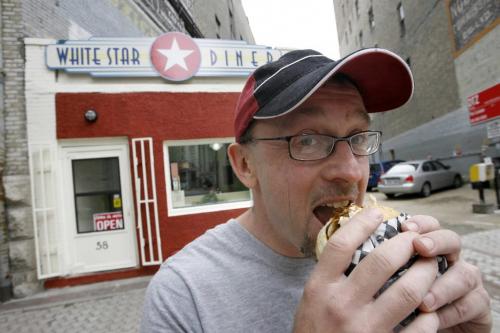 MIKE.DEAL@FREEPRESS.MB.CA 090716 Bruce Smedts proprietor of the White Star Diner at 58 Albert Street holds one of his popular pulled pork sandwiches. WINNIPEG FREE PRESS