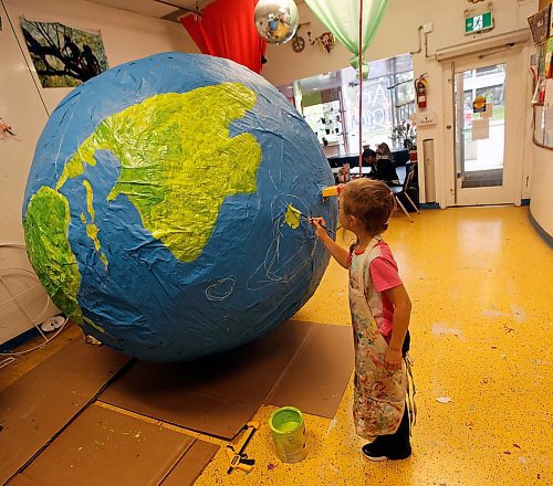 PHIL HOSSACK / WINNIPEG FREE PRESS -  8 yr old Emma Loshakova works Tuesday afternoon on a giant paper mâché globe at Art City for the Global Climate Strike to be held here Friday. Eva's story. - September 24, 2019.