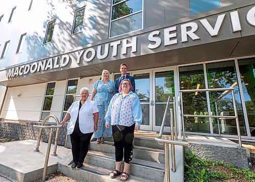 SASHA SEFTER / WINNIPEG FREE PRESS
(Back row, from left) Macdonald Youth Services Chief Executive Officer Kerri Irvin-Ross and MYS Board Chairperson Jim Krovats, (front row from left) longtime MYS foster mom Ursula Delaronde and former MYS client Breeze Foy gather together for a photo on the front steps of Macdonald Youth Services headquarters at 175 Mayfair Avenue in River-Osborne.
190829 - Thursday, August 29, 2019.