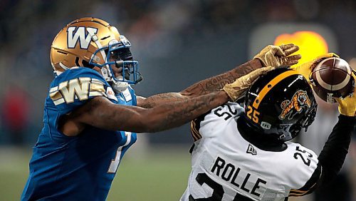 Phil Hossack / Winnipeg Free Press - Winnipeg Blue Bomber #1 Darvin Adams reaches for his intended pass as  Hamilton Tiger Car #25 Jumal Rolle takes it from his grasp late in the game at IGFiled Friday night. - Sept 27, 2019.
