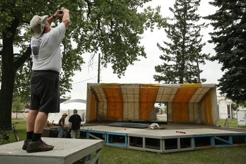 Brandon Sun Richard Harby takes a photograph of the main stage Thursday afternoon during preparations for this weekend's Brandon Folk, Music and Art Festival at the Keystone Centre grounds. The gate opens at 6:30 p.m. today for the festival's 25th anniversary. (Colin Corneau/Brandon Sun)