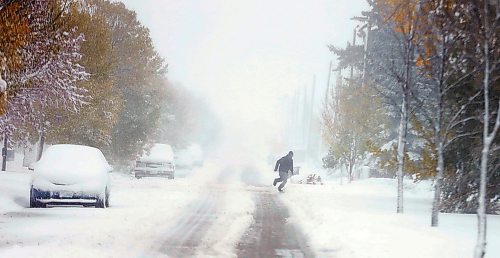 PHIL HOSSACK / WINNIPEG FREE PRESS - STAND-UP  - A pedestrian struggling up John Bruce Road runs for cover in winds gusting to 90km created by the storm.  - October 11, 2019.