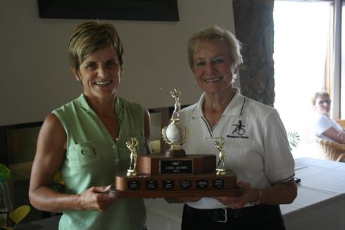 Brandon Sun Shauna Danyluk receives the Zeke's Women's Western Open Trophy from tournament chairwoman Shirley Bray for the sixth time at the Wheat City Golf Course on Sunday. Danyluk shot a 77 to win the 76th annual tournament by five strokes over Chris Coulter. (Keith Borkowsky/Brandon Sun)