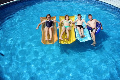 Brandon Sun (Matt Goerzen/Brandon Sun) Carberry quadruplets Janelle, left, Maryn, Gregory and Myles Lavich, seen here lounging in a family friend's pool in Brandon this week, celebrate their 13th birthday on Aug. 17.