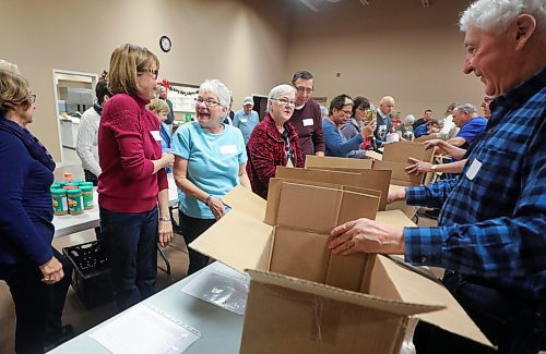RUTH BONNEVILLE  /  WINNIPEG FREE PRESS 

FAITH - packing hampers at 
Charleswood United Church.

Volunteers from Charleswood United church  celebrate as they start packing their 50th hamper, which is their last one for the Christmas Cheer Board on Friday morning.

According to the Cheer Board, they are the single-largest private provider of hampers. 
John Longhurst story 

Dec 13th,    2019