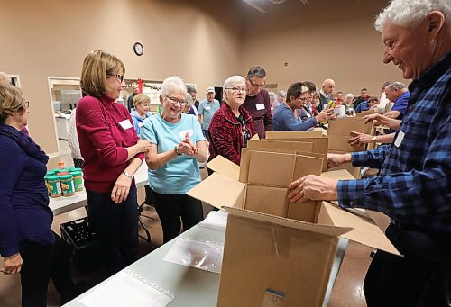 RUTH BONNEVILLE  /  WINNIPEG FREE PRESS 

FAITH - packing hampers at 
Charleswood United Church.

Volunteers from Charleswood United church  celebrate as they start packing their 50th hamper, which is their last one for the Christmas Cheer Board on Friday morning.

According to the Cheer Board, they are the single-largest private provider of hampers. 
John Longhurst story 

Dec 13th,    2019