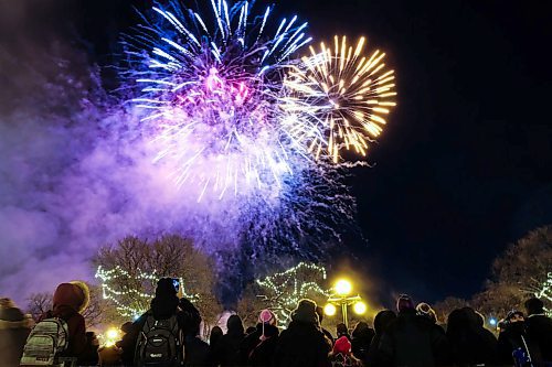 Daniel Crump / Winnipeg Free Press. Spectators watch fireworks at the Illuminate 150 celebration at the Manitoba Legislature. December 14, 2019.