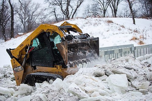 MIKAELA MACKENZIE / WINNIPEG FREE PRESS

A sub-contractor works on making the ice at the edges of the path less sharp at the Omand's Creek bridge in Winnipeg on Monday, Dec. 16, 2019. 
Winnipeg Free Press 2019.