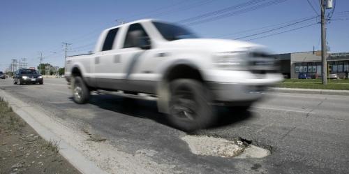 MIKE.DEAL@FREEPRESS.MB.CA 090825 A large pothole on South bound Route 90. See Bartley Kives story.  WINNIPEG FREE PRESS