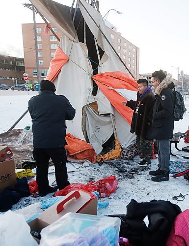 JOHN WOODS / WINNIPEG FREE PRESS
Jenna Wirch and Michael Champagne, right, speak to a man outside a warming teepee that was set up at a homeless camp outside the Salvation Army and Main Street Project on Austin at Henry Tuesday, December 17, 2019.  Wirch and a group of volunteers from the harm reduction and Indigenous communities have raised a teepee with a fire pit at the homeless camp at the corner of Austin Street and Henry Avenue so homeless people who arent able to access nearby shelters can stay warm through the winter.

Reporter: Da Silva