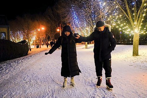 Mike Sudoma / Winnipeg Free Press
Jed Martin Orellano (right) gives Nina Buevos (left) a helping hand as the two make their way down the light up ice skating trail at The Forks Friday evening
December 26, 2019