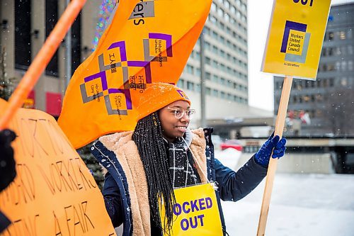 MIKAELA MACKENZIE / WINNIPEG FREE PRESS

Anntonette Jackson holds a sign at a union rally of Tim Hortons employees outside of 1 Lombard Place in Winnipeg on Friday, Jan. 3, 2020. For Ben Waldman story.
Winnipeg Free Press 2019.