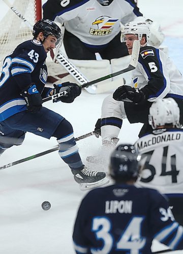SHANNON VANRAES / WINNIPEG FREE PRESS
Dan Renouf of the Colorado Eagles watches the puck as Skylar McKenzie of the Manitoba Moose closes in during the first period of a game at MTS Centre in Winnipeg on January 3, 2020.
