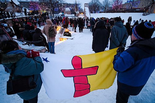 Daniel Crump / Winnipeg Free Press. Attendees hold an Inuit flag during a vigil in memory of singer Kelly Fraser at the Odena Circle at The Forks. January 4, 2020.
