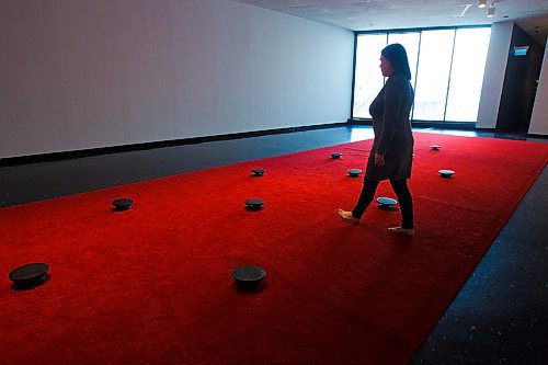 MIKE DEAL / WINNIPEG FREE PRESS
A person walks amongst the speakers in the red carpet of the Prayer exhibit by James Webb at the WAG. 
According to the WAG, "The work consists of recordings of prayer from individuals who belong to dozens of faiths and spiritual affinities in the host city. Listeners are invited to remove their shoes and walk the length of the carpet, composing their own arrangement of voices as they go, or to kneel or otherwise lower themselves next to a speaker to listen more closely to particular prayers."
200106 - Monday, January 06, 2020.