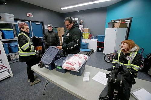 SHANNON VANRAES / WINNIPEG FREE PRESS
Travis Bighetty of the Broadway Bear Clan Patrol opens a storage container as Angela Janeczko looks on. They were preparing for a Friday night patrol at the organization's "den" inside the Broadway Neighbourhood Centre on January 10, 2020.
