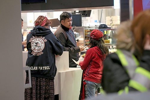 SHANNON VANRAES / WINNIPEG FREE PRESS
Lara Rae orders hot drinks for the West Broadway Bear Clan Patrol during a Friday night patrol. Volunteers headed into a McDonald's restaurant to warm up at the halfway point of their three-hour-long patrol.