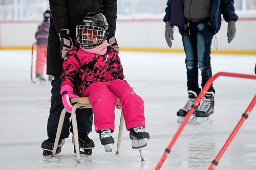 Daniel Crump / Winnipeg Free Press. Carol Reimer (black jacket) pushes Letesus Takeia (pink jacket) around on a chair during the Welcome to Winnipeg skating event at Camp Manitou. January 11, 2020.