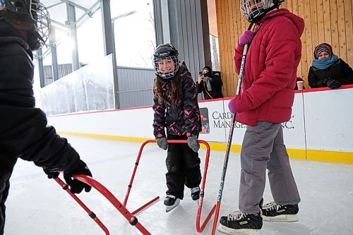 Daniel Crump / Winnipeg Free Press. Sandi Azab (middle) skates with the help of a support device during the True North Youth  Foundation's Welcome to Winnipeg skating event at Camp Manitou. January 11, 2020.