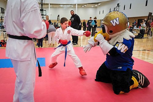 Daniel Crump / Winnipeg Free Press. Blue belt, Easton Farrell (middle) takes on Winnipeg Blue Bombers mascot Buzz (right) during a karate demonstration at Sport Manitoba's Game Day. The open house style event allows kids to try out more than a dozen sports, including karate, fencing, rowing and gymnastics. January 11, 2020.