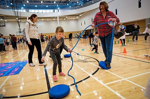Daniel Crump / Winnipeg Free Press. Sara Lagrange (left) plays a game of tug-o-war with her grandmother Cec Hanec (right) at Sport Manitoba's Game Day. The event is designed to allow kids to get a taste of a wide variety of sports. January 11, 2020.