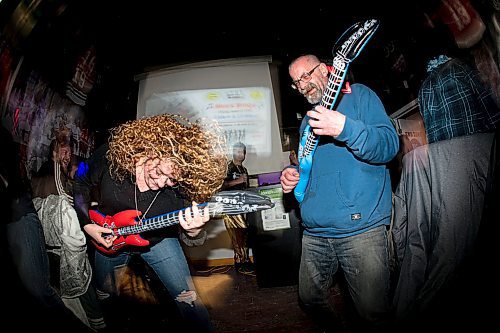 Mike Sudoma / Winnipeg Free Press
Johanna Hansen and Chris Lamanne duel out air guitars for. Drink ticket during Friday evenings Music Bingo event at 4th Line Pub and Grill in St James
January 10, 2020