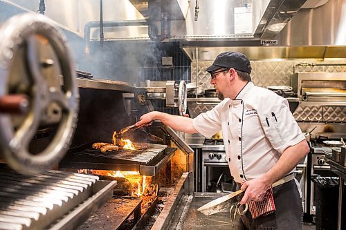 MIKAELA MACKENZIE / WINNIPEG FREE PRESS

Executive chef Brian Roloff turns the sausages on the wood-fired grill at The Wood Tavern in the Norwood Hotel in Winnipeg on Tuesday, Jan. 14, 2020. 
Winnipeg Free Press 2019.