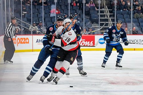 Daniel Crump / Winnipeg Free Press. Manitobas Andrei Chibisov (48) catches Bellevilles Morgan Klimchuk (18) with a high stick as the two teams battled it out Wednesday evening at Bell MTS Place, Winnipeg. January 15, 2020.