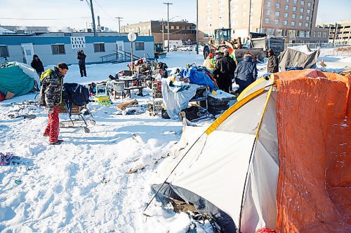 MIKE DEAL / WINNIPEG FREE PRESS
Kyle (left) who has been at the homeless camp for several months starts to move some of his belongings to a friends tent so that the city can start cleaning up the site Thursday morning. The people living in the camps have have been asked to move by the City of Winnipeg for safety reasons.
200116 - Thursday, January 16, 2020.