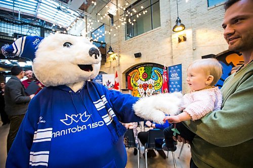 MIKAELA MACKENZIE / WINNIPEG FREE PRESS

Toba, the Manitoba 150 mascot, says hi to Klara Morgenstern (10 months) and her dad, Kevin Morgenstern, before the minister of Canadian heritage announces support for the Manitoba 150 Host Committee at The Forks in Winnipeg on Tuesday, Jan. 21, 2020. For Kevin Rollason story.
Winnipeg Free Press 2019.