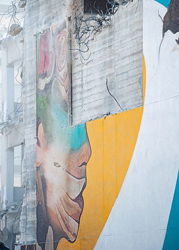 Mike Sudoma / Winnipeg Free Press
Rubble falls above the remnants of a mural done by artist, Mike Valcourt, as demolition of the Public Safety begins Tuesday afternoon
January 21, 2020