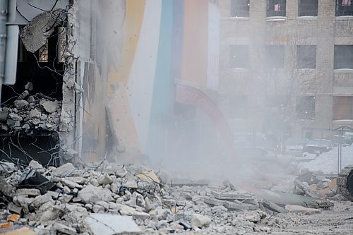 Mike Sudoma / Winnipeg Free Press
An exit only sign barely hangs on as rubble and debris fall form the Public Safety Building as demolition crews start to take down the old parkade Tuesday afternoon
January 21, 2020