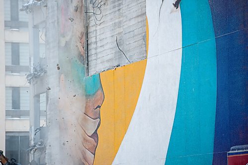 Mike Sudoma / Winnipeg Free Press
Rubble falls above the remnants of a mural done by artist, Mike Valcourt, as demolition of the Public Safety begins Tuesday afternoon
January 21, 2020