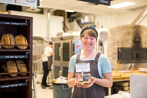 MIKAELA MACKENZIE / WINNIPEG FREE PRESS

Employee Jessie Dyck shows off the pay-it-forward button jar at Hildegards Bakery in Winnipeg on Friday, Jan. 24, 2020. For Maggie Macintosh story.
Winnipeg Free Press 2019.